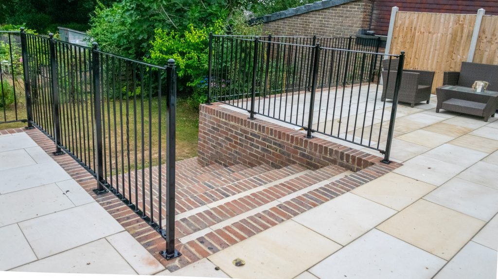 Patio railing, next to steps