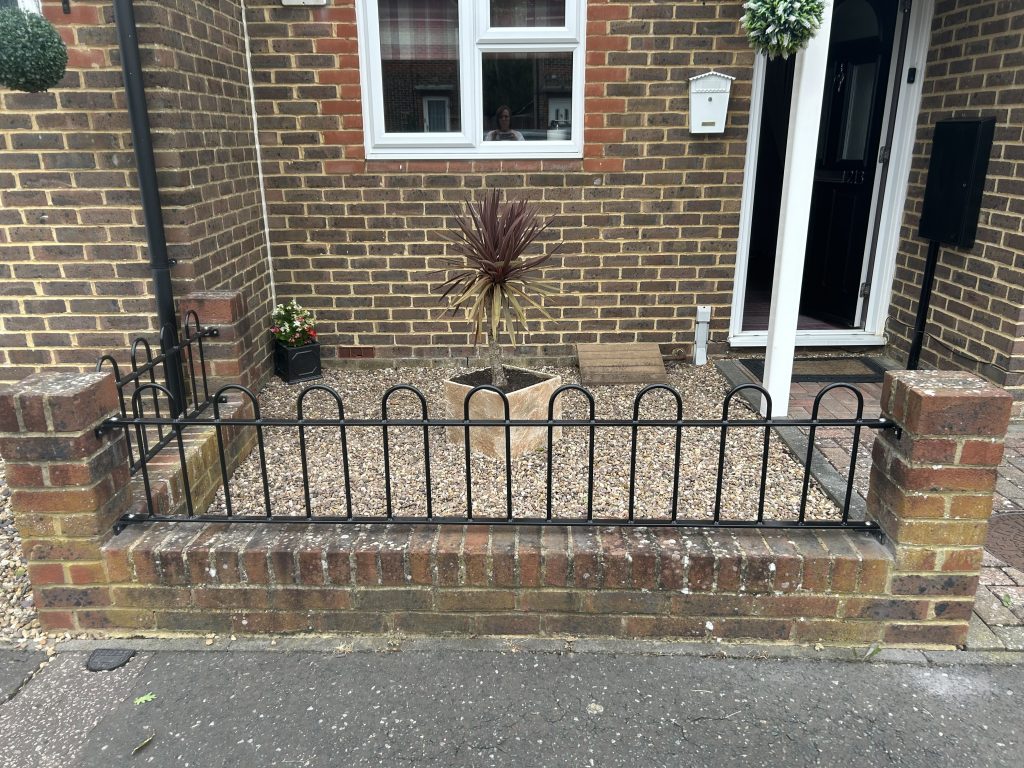 hoop railings on a low garden wall