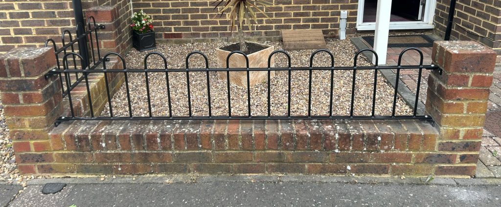 Hoop railings on garden wall